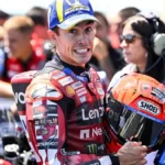 Marc Marquez pembalap Ducati Lenovo Team memegang helm saat menghadiri paddock MotoGP