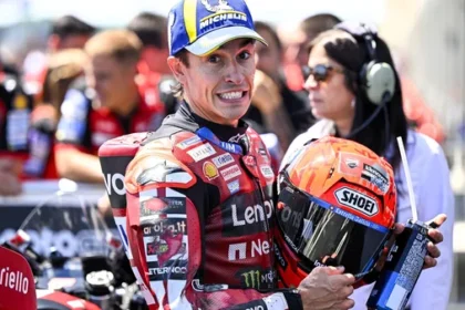 Marc Marquez pembalap Ducati Lenovo Team memegang helm saat menghadiri paddock MotoGP