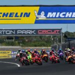 Rombongan pembalap MotoGP melaju di Sirkuit Balaton Park pada MotoGP Hungaria dengan papan Michelin di atas lintasan.